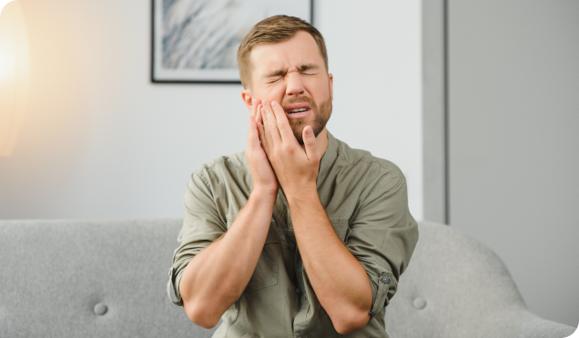 A man with severe toothache, emphasizing the need for prompt dental emergency services.